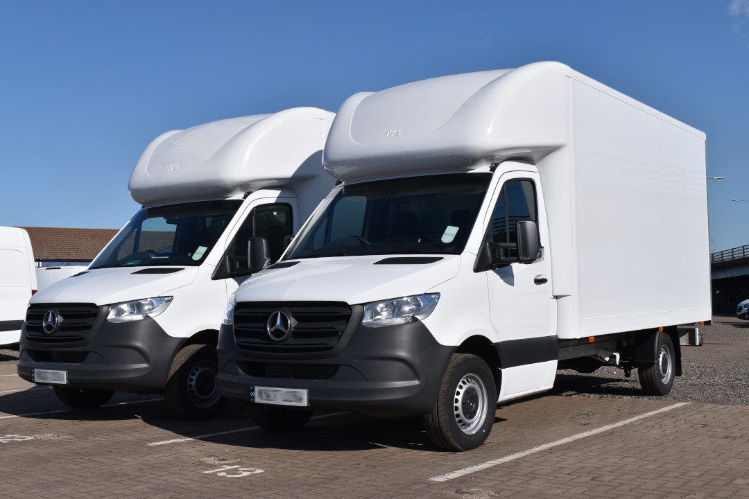 Photo of a white Luton-style box van parked on a roadside